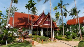 A traditional Thai building with a red roof, surrounded by palm trees and a well-maintained garden. - Royal Lanta Resort & Spa (Ko Lanta)