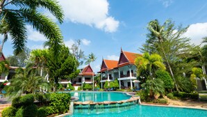 A resort with a swimming pool, palm trees, and traditional architecture. - Royal Lanta Resort & Spa (Ko Lanta)