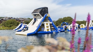 An inflatable water park with slides and a climbing structure. - Retallack Resort (St. Columb Major)