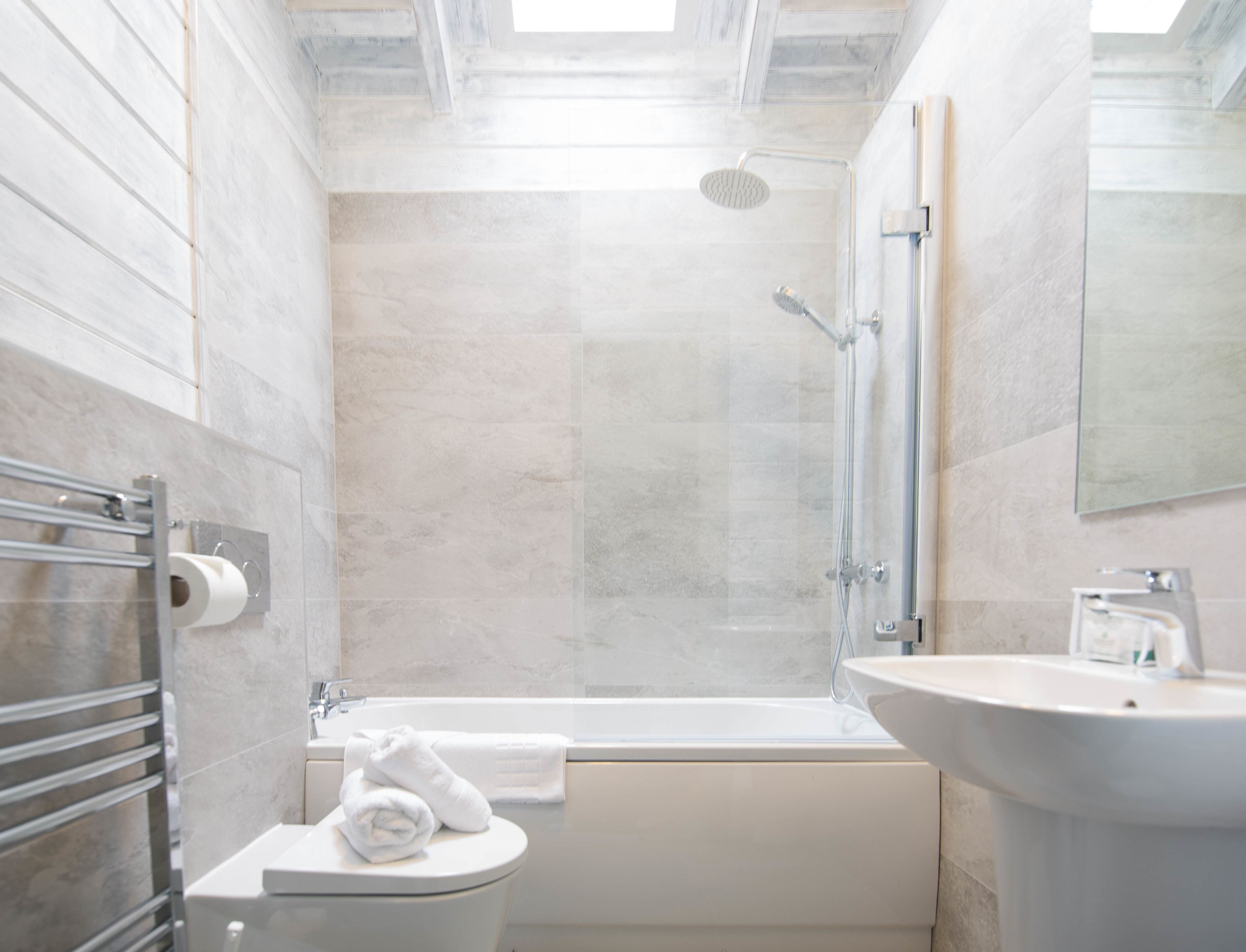 Ein modernes Badezimmer mit Badewanne, Toilette und Waschbecken.