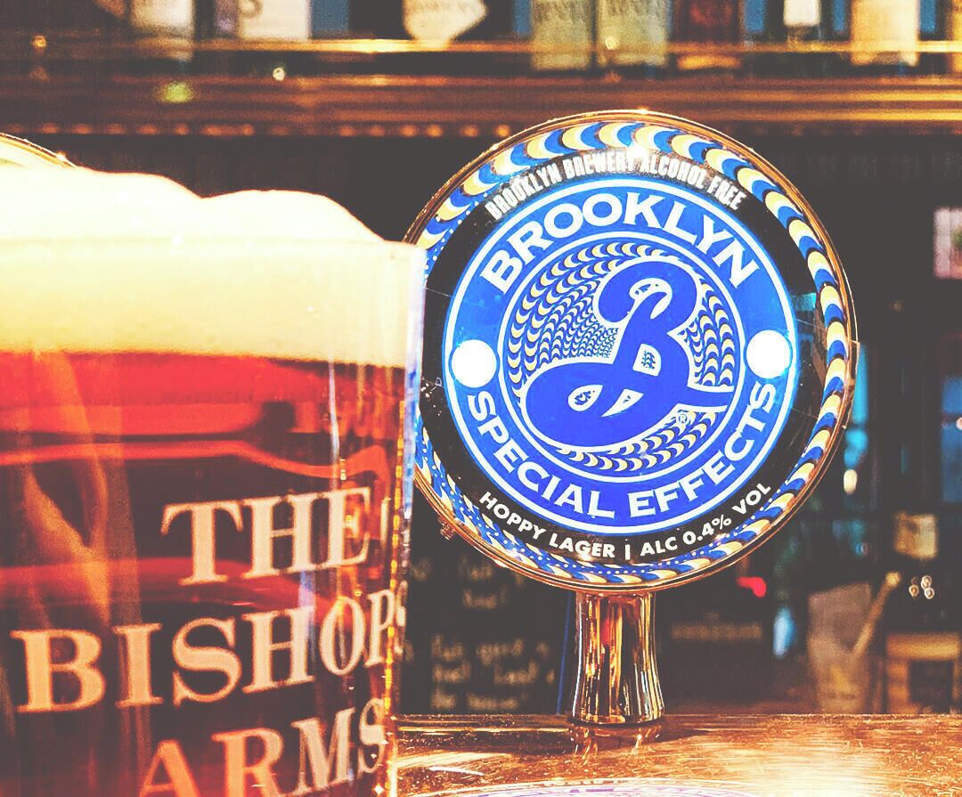 A beer tap with the label "Brooklyn Special Effect" and a glass of beer in the foreground.
