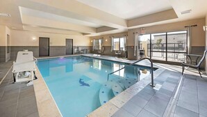 An indoor swimming pool with a clear view of the pool area, including the poolside seating and the pool's edge. - Best Western Plus Tupelo Inn & Suites (Tupelo)