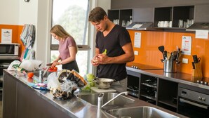 A modern kitchen with stainless steel appliances, a large window, and a sink. - The Island Accommodation (Newhaven)