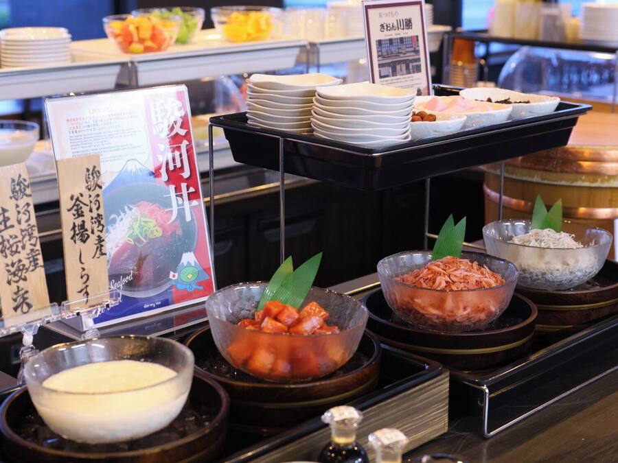 A buffet setup with various food items and condiments.