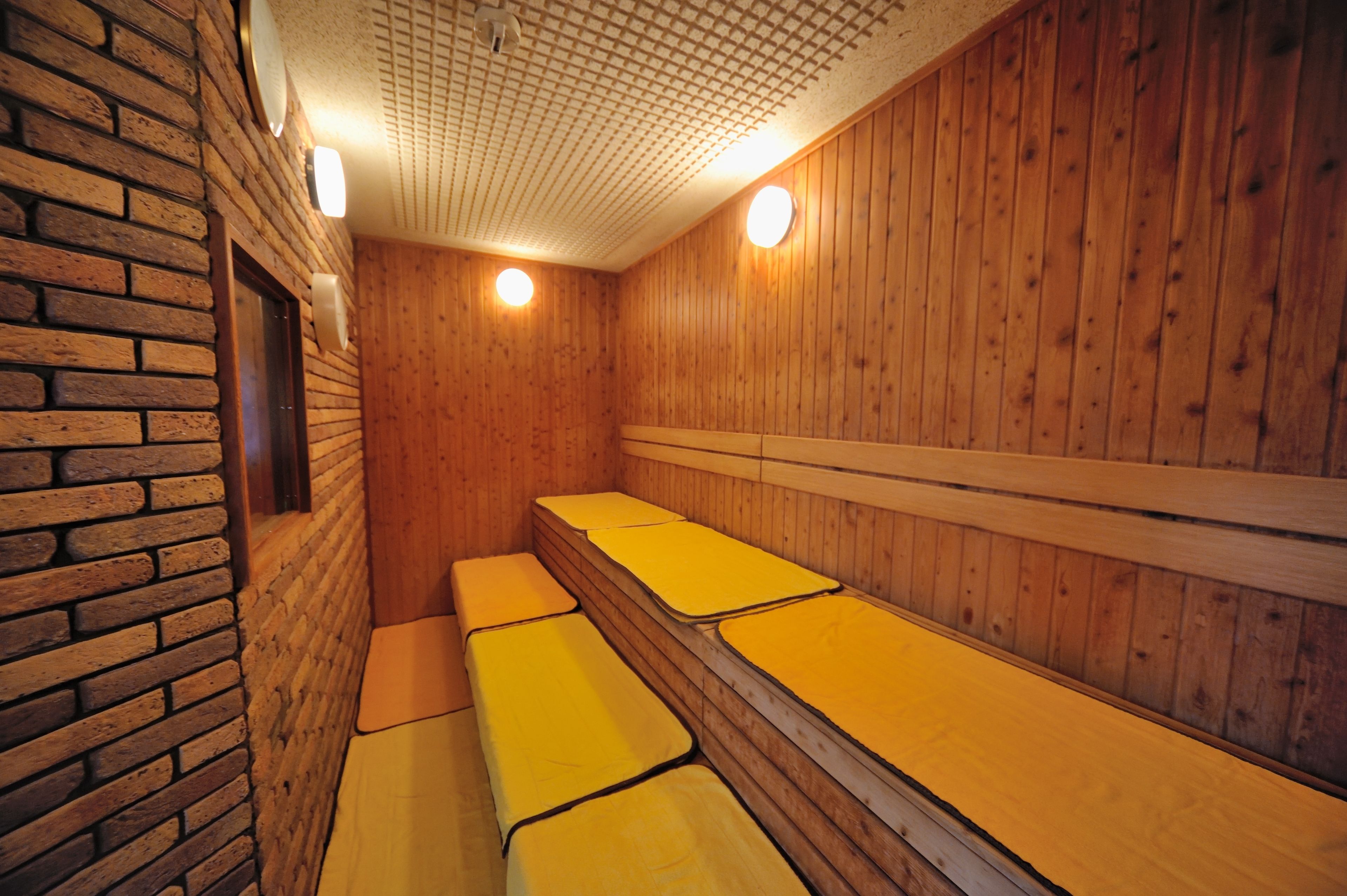 A sauna with wooden walls and benches.