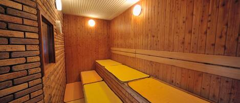 A sauna with wooden walls and benches.