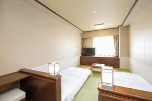 A hotel room with two beds, a TV, a desk, and a window with curtains. - Dormy Inn Premium Otaru Natural Hot Spring (Otaru)