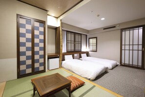 A hotel room with two beds, a desk, a small refrigerator, and traditional sliding doors. - Dormy Inn Premium Otaru Natural Hot Spring (Otaru)