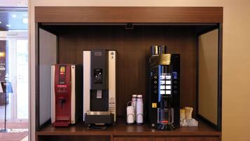 A minibar with a hot water dispenser, a beverage dispenser, and a coffee machine.