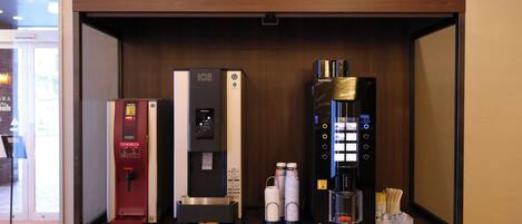 A minibar with a hot water dispenser, a beverage dispenser, and a coffee machine.
