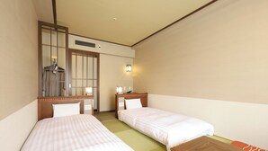 A hotel room with two single beds, a wooden table, a mirror, and a wardrobe. - Dormy Inn Premium Otaru Natural Hot Spring (Otaru)