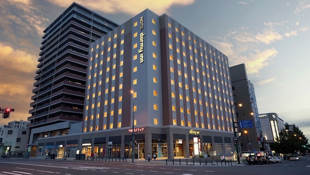 A multi-story hotel with a modern design, featuring a prominent 'Inn Inn' sign on the facade. - Dormy Inn Premium Otaru Natural Hot Spring (Otaru)