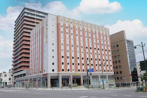 A multi-story hotel with a modern facade, a ground-level entrance, and a visible sign for a restaurant. - Dormy Inn Premium Otaru Natural Hot Spring (Otaru)