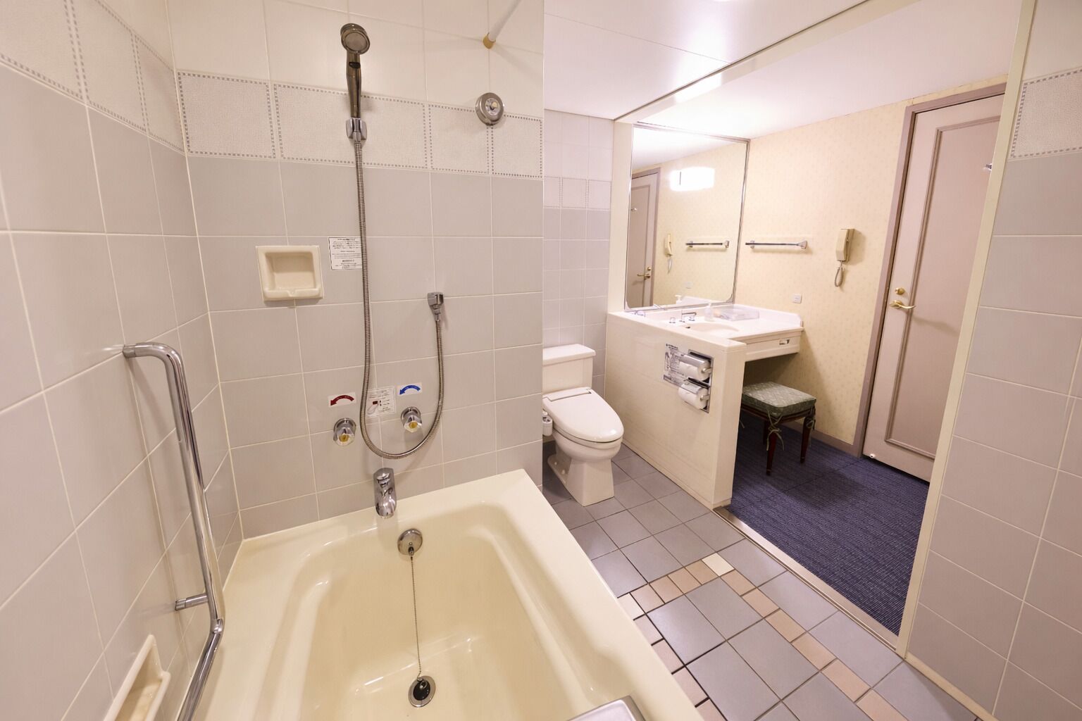A bathroom with a bathtub, toilet, and shower.
