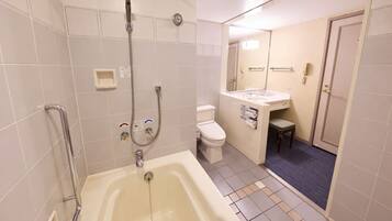A bathroom with a bathtub, toilet, and shower.