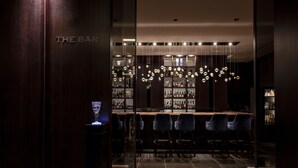 A bar with a modern design, featuring hanging spherical light fixtures and a dark wood finish. - The Royal Park Hotel Kyoto Sanjo (Kyoto)