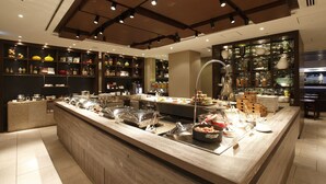A buffet area with various food stations and a well-lit interior. - The Royal Park Hotel Kyoto Sanjo (Kyoto)