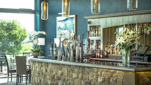 A bar area with a stone counter, multiple taps, and a variety of bottles. - The Coniston Hotel and Country Estate (Skipton)