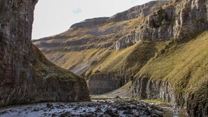 A rocky canyon with steep cliffs and a narrow stream. - The Coniston Hotel (Skipton)