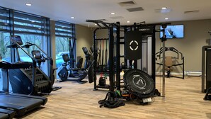 A gym with treadmills, ellipticals, and weightlifting equipment. - The Coniston Hotel (Skipton)