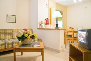 Basic Studio, City View | Living area | TV