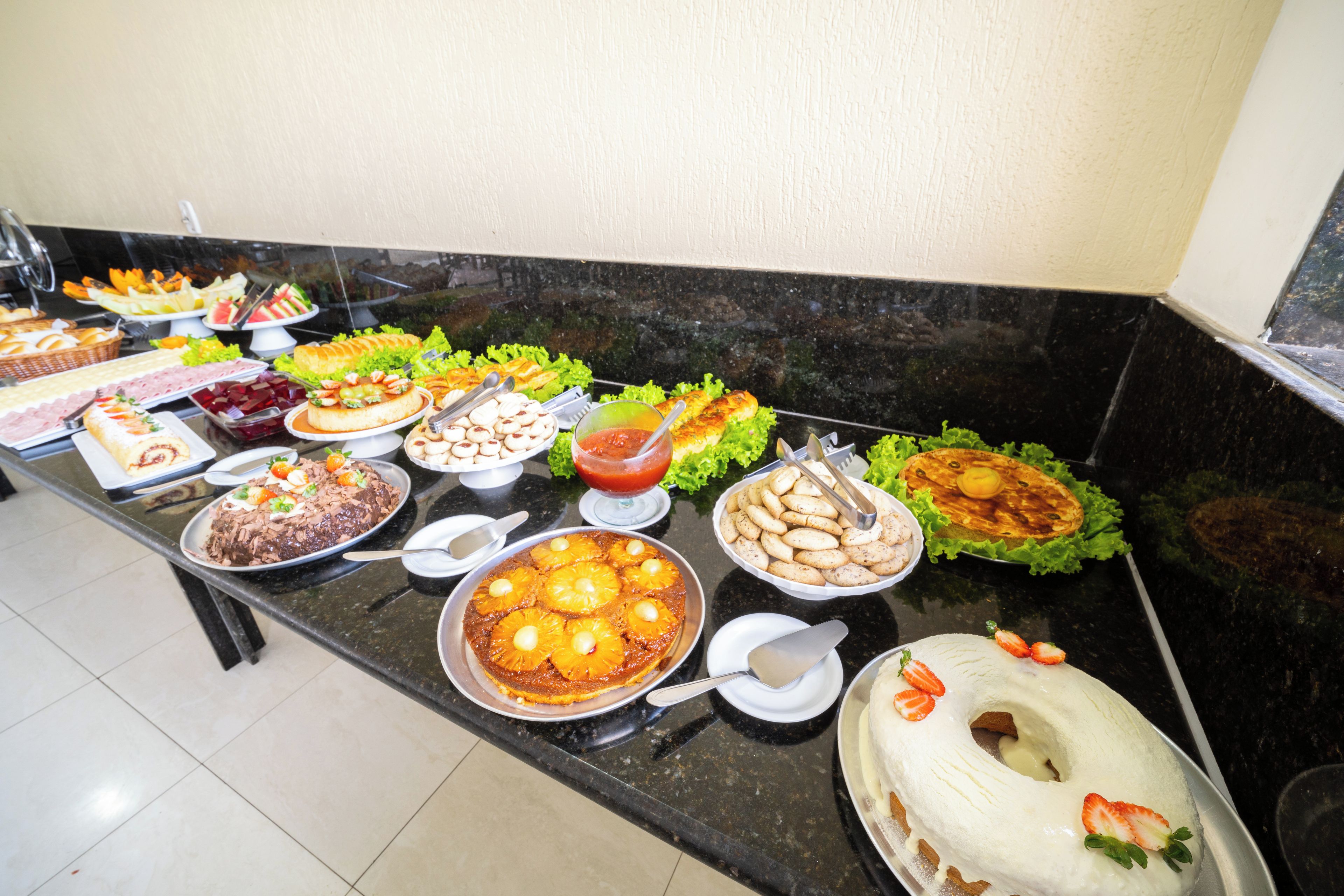 A buffet table with various food items and a cake.