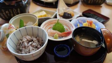 A tray with various dishes including rice, shrimp, and soup.