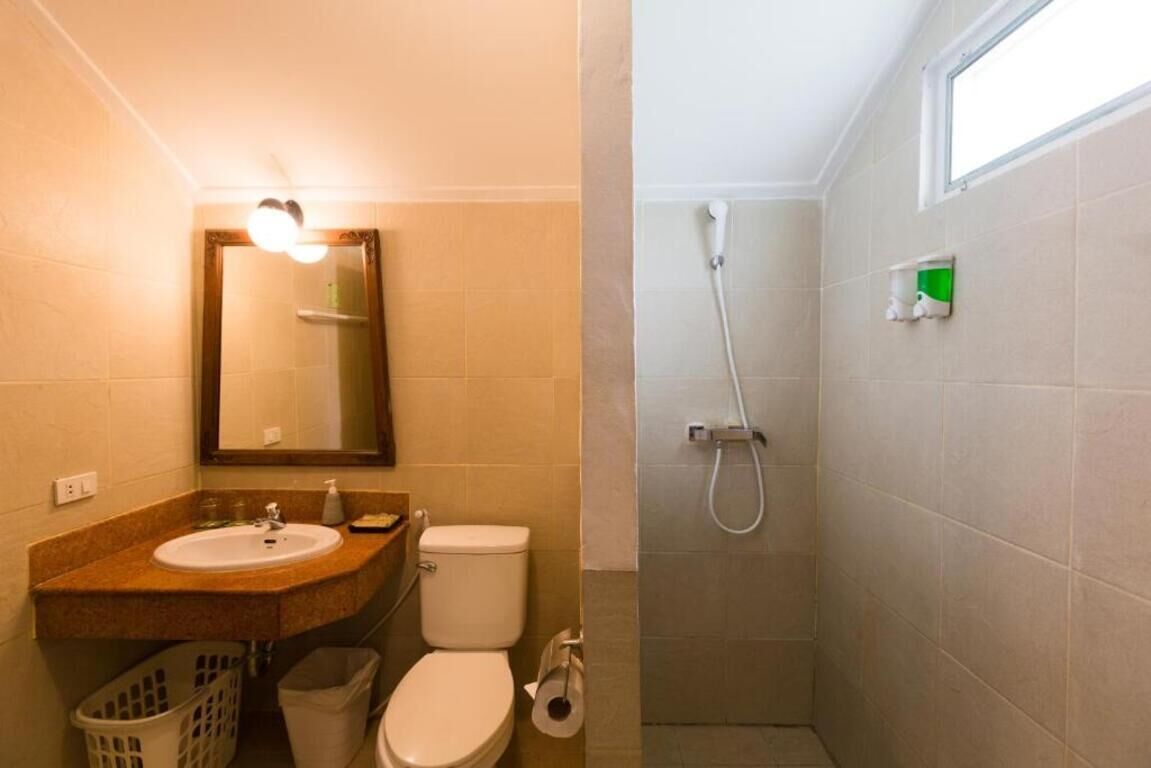A bathroom with a sink, toilet, and shower.