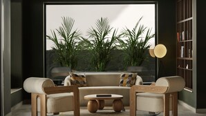Uma sala de estar moderna com um sofá, uma mesa de centro e uma estante de livros.