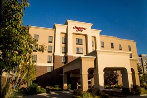 A multi-story hotel with a prominent 'Marriott' sign, featuring a classic architectural design with a beige facade and multiple windows.