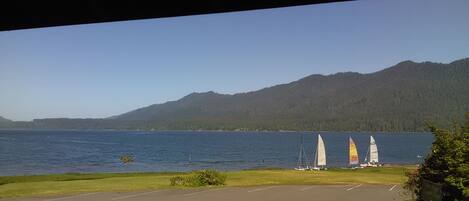 A parking lot with a view of a lake and mountains.