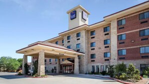 A hotel with a central entrance, multiple floors, and a prominent sign. - Sleep Inn & Suites Lubbock West (Lubbock)