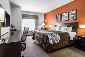 A hotel room with a bed, bedside tables, a desk, a chair, and a TV. - Sleep Inn & Suites Lubbock West (Lubbock)