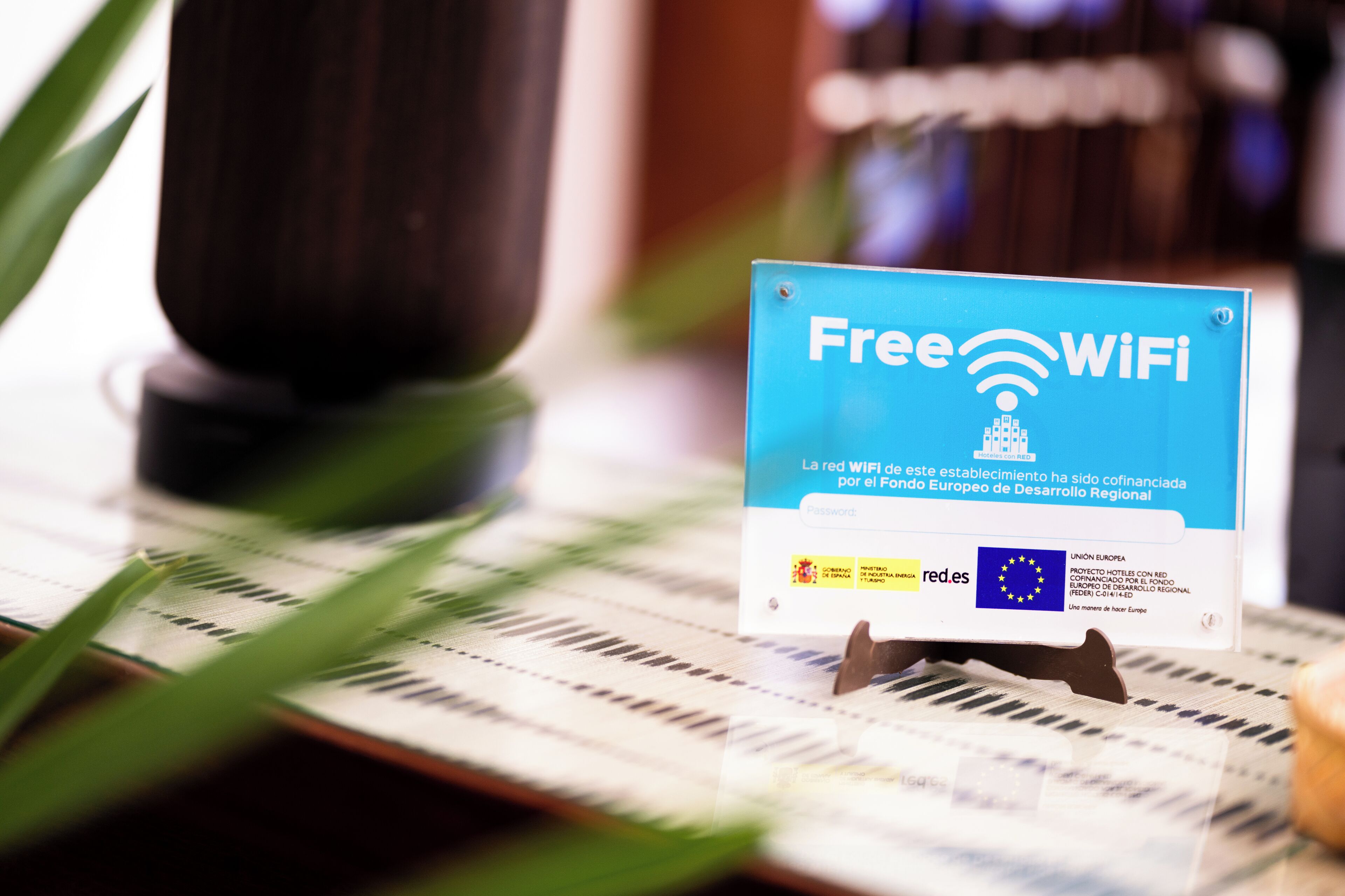 A sign indicating free WiFi availability, with logos of the European Union and a regional development fund.