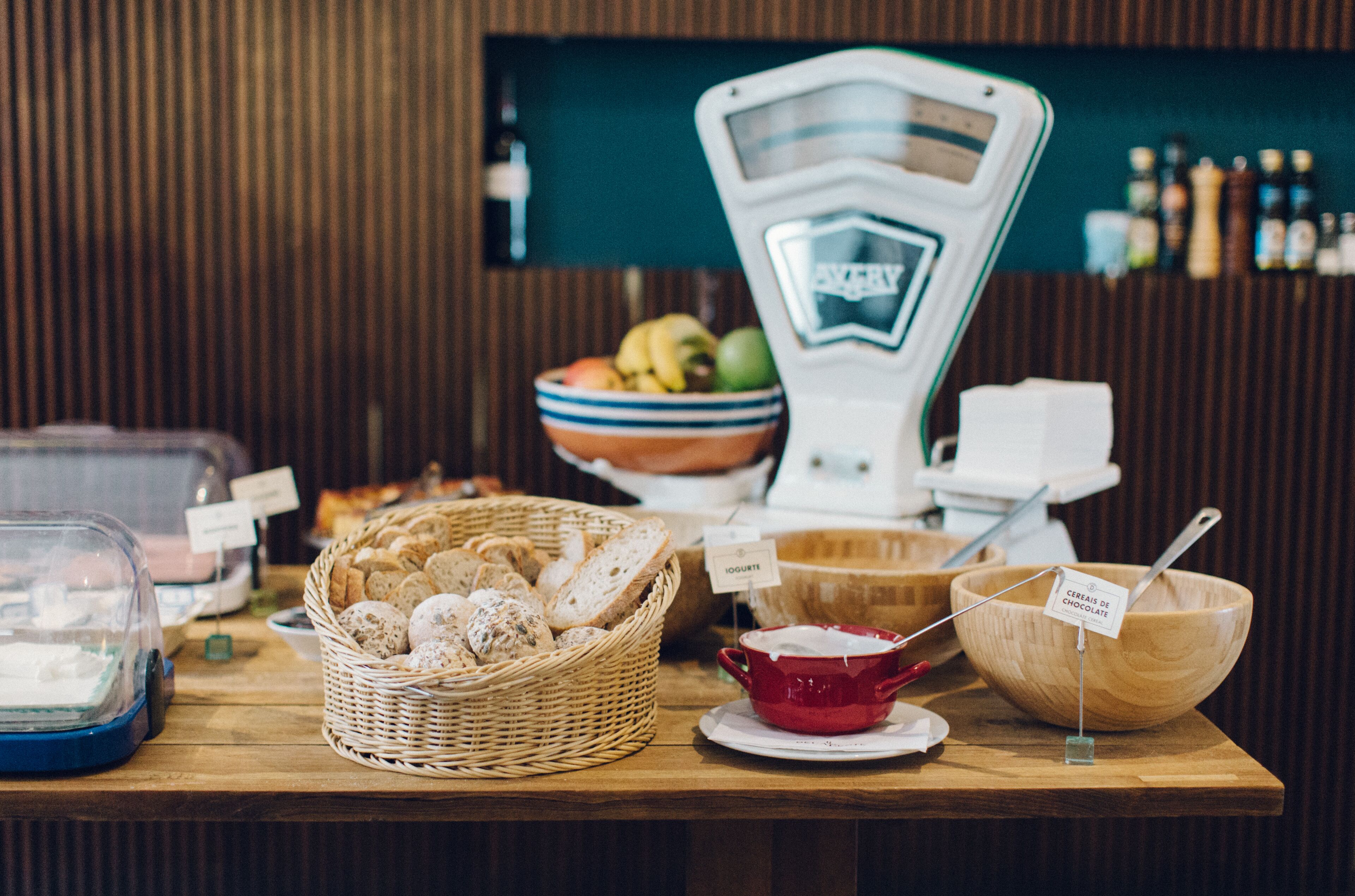 A buffet setup with various food items and a weighing scale.