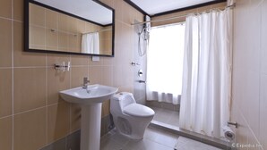 A bathroom with a sink, toilet, and shower. - Richmond Plaza Hotel (Cebu City)