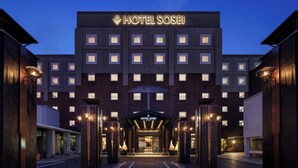 A modern hotel entrance with a prominent sign, a covered walkway, and uniform windows. - Hotel Sosei Sapporo - MGallery Collection (Sapporo)