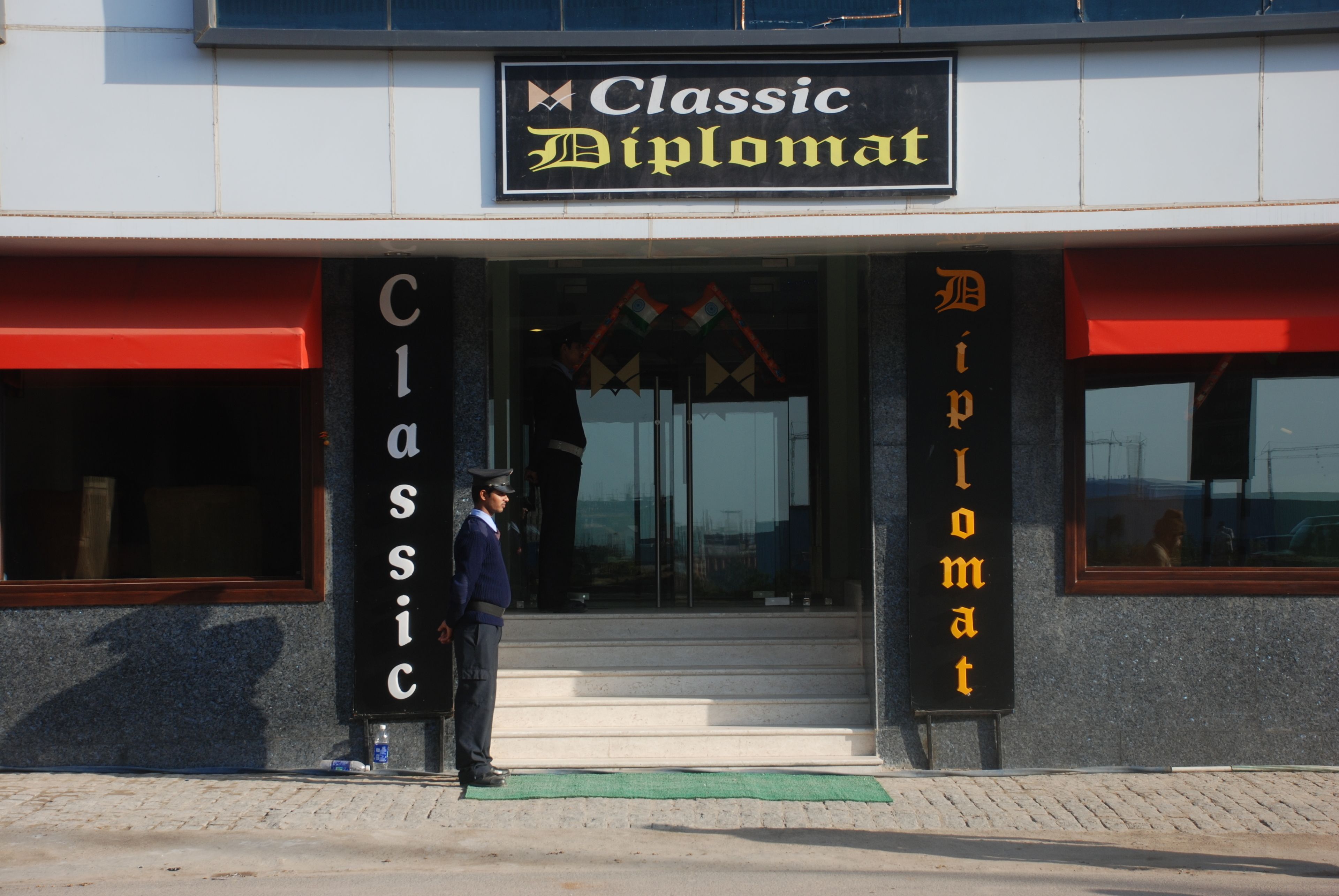 A building with a sign reading "Classic Diplomat".