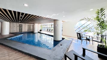 Indoor pool, open 8:00 AM to 7:00 PM, pool loungers