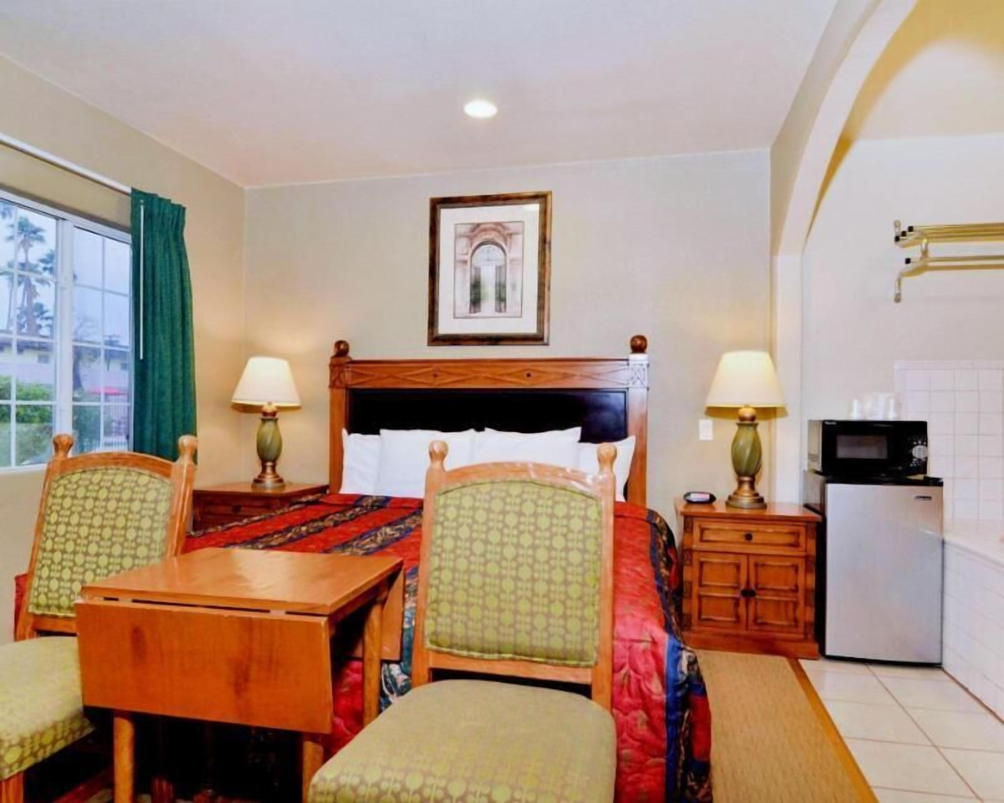 Desk, blackout drapes, iron/ironing board, bed sheets