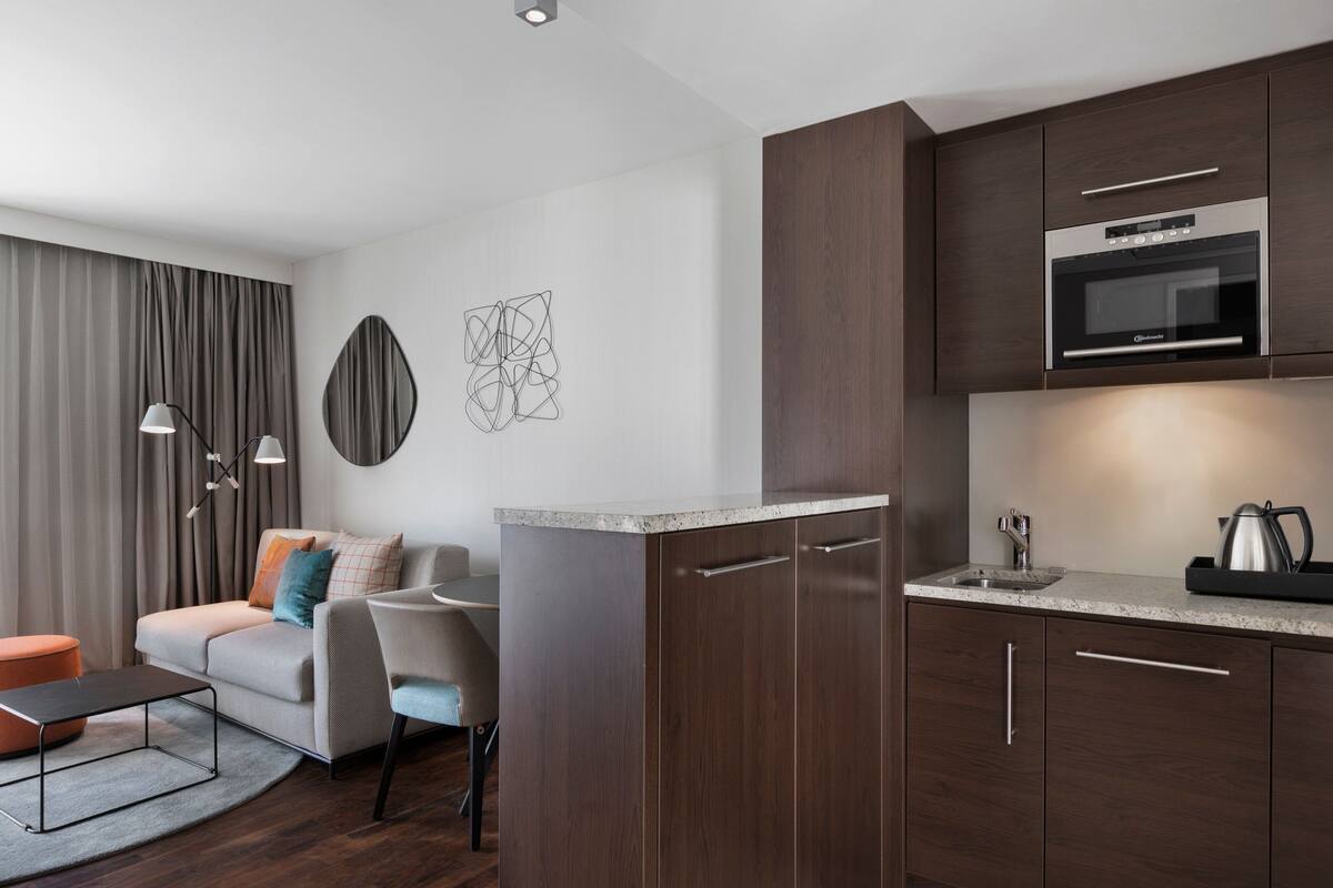 family studio, 1 queen bed with sofa bed, corner | private kitchen | fridge, microwave, stovetop, dishwasher
