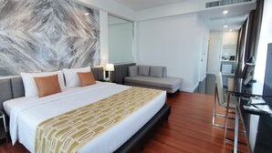 A modern hotel room with a large bed, a sofa, a desk, and a marble wall. - The Bless Hotel and Residence (Bangkok)