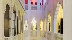 A courtyard with multiple arches and balconies, featuring intricate lattice work and traditional architectural elements. - Jyoti Mahal A Royal Heritage Hotel - 5 Mins from New Delhi Railway station & 2Mins From Metro (New Delhi)