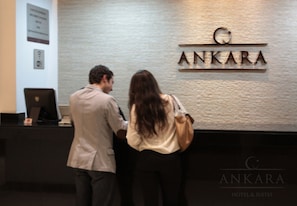 A reception desk with the name "ANKARA HOTEL & SUITES" displayed above it. - Hotel Ankara Las Lomas (San Luis Potosi)