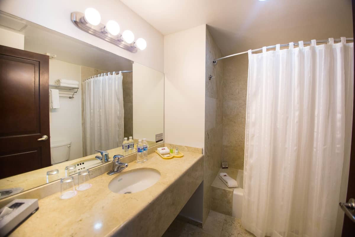 junior suite, 2 double beds, balcony (expedia) | bathroom | free toiletries, hair dryer, towels, soap