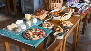 A buffet table with various cheeses, breads, pastries, and desserts. - Loc Hotel Alpen Sports (Les Gets)