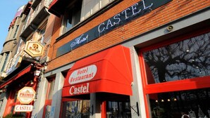 A hotel named 'CASTEL' with a red awning and signage. - Hotel Castel (Ghent)