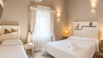 A hotel room with a bed, a chair, a nightstand, an air conditioning unit, and a window with curtains.