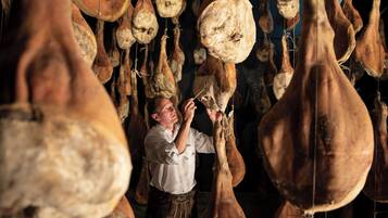 A person inspecting large dried gourds in a dimly lit room.