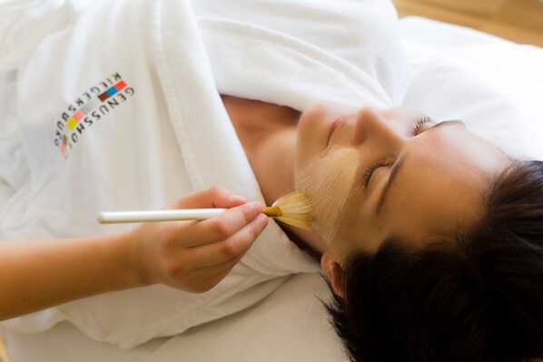 A person lying down with a brush on their face.